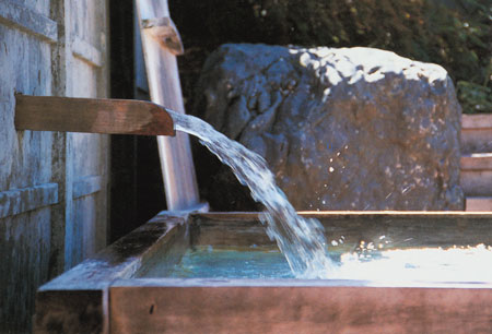 The Japanese bathing ritual has four steps. Seated on a low stool, the bather uses a bucket to rinse away dirt with hot water scooped from the prepared bath, then descends into the tub for a first soak. Reemerging, the bather sits on the stool and scrubs with soap and loofah, then rinses thoroughly. The final step is a relaxing, second soak in the tub. Traditional baths call for an outdoor setting or a room that opens to the outdoors.
